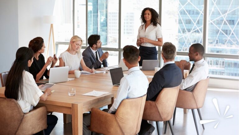 Leader speaking to a diverse team in a boardroom, representing company culture and leadership during growth