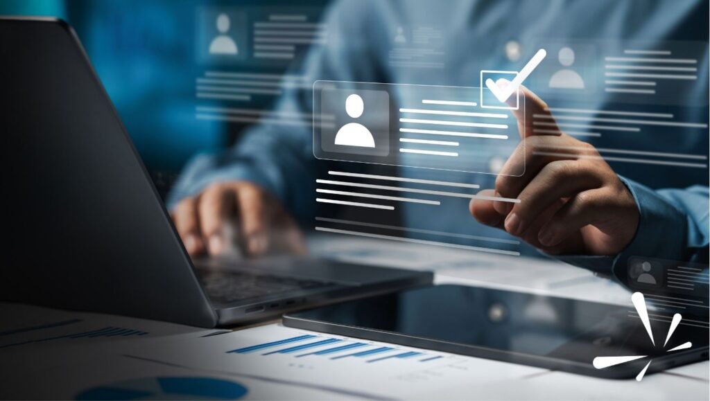 Person using laptop with digital HR profile icons and AI checkmark interface, representing AI in HR technology